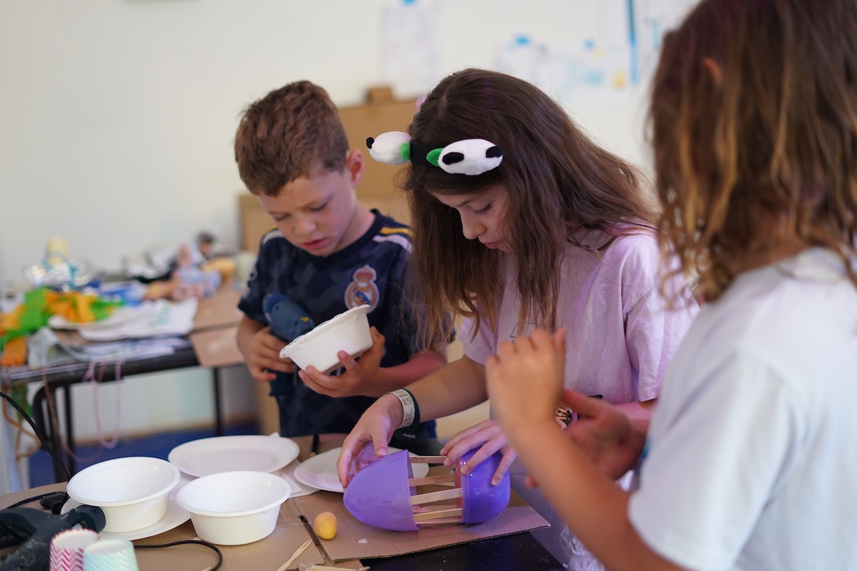 children at the studio table working on a model