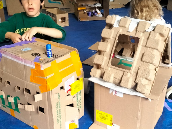 a boy modelmaking in the gallery space